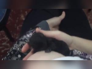 Woman and puppy in an intense milking session