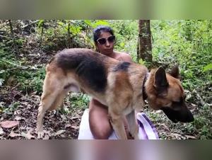 Latin woman and dog in the woods