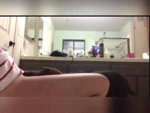 Beautiful blonde and dog in the bathroom